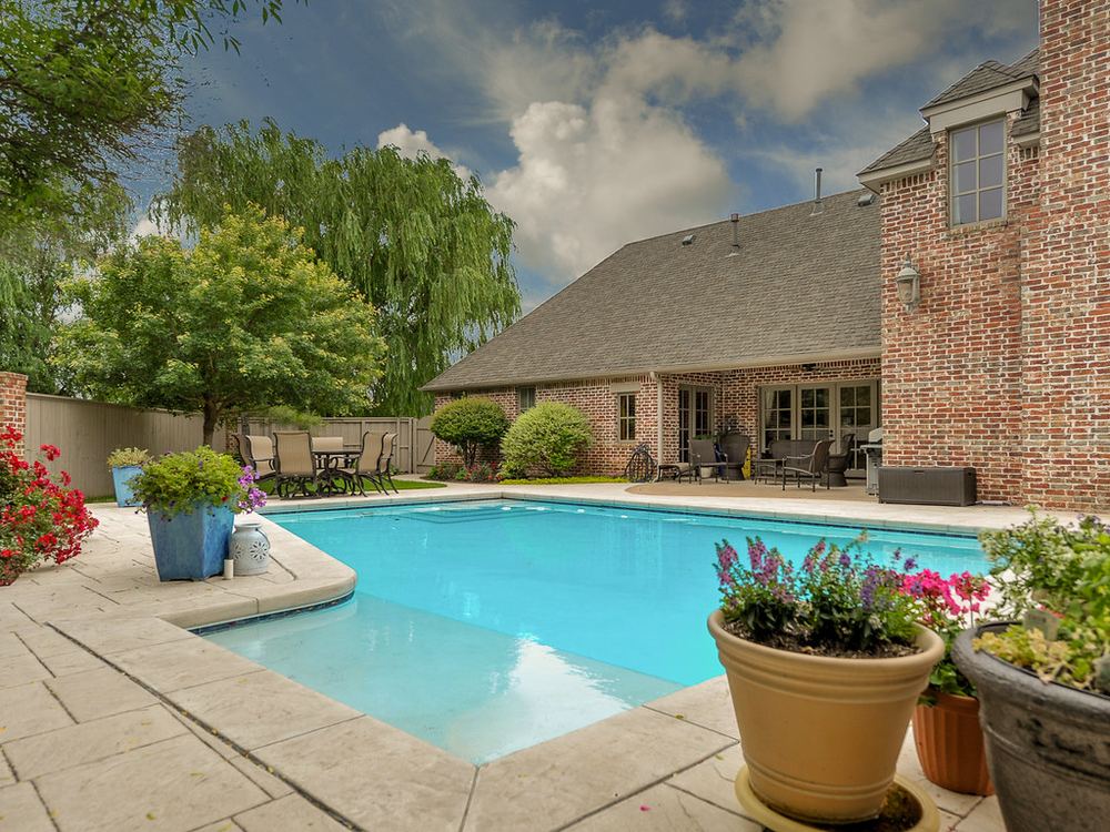 Backyard swimming pool with concrete surrounds
