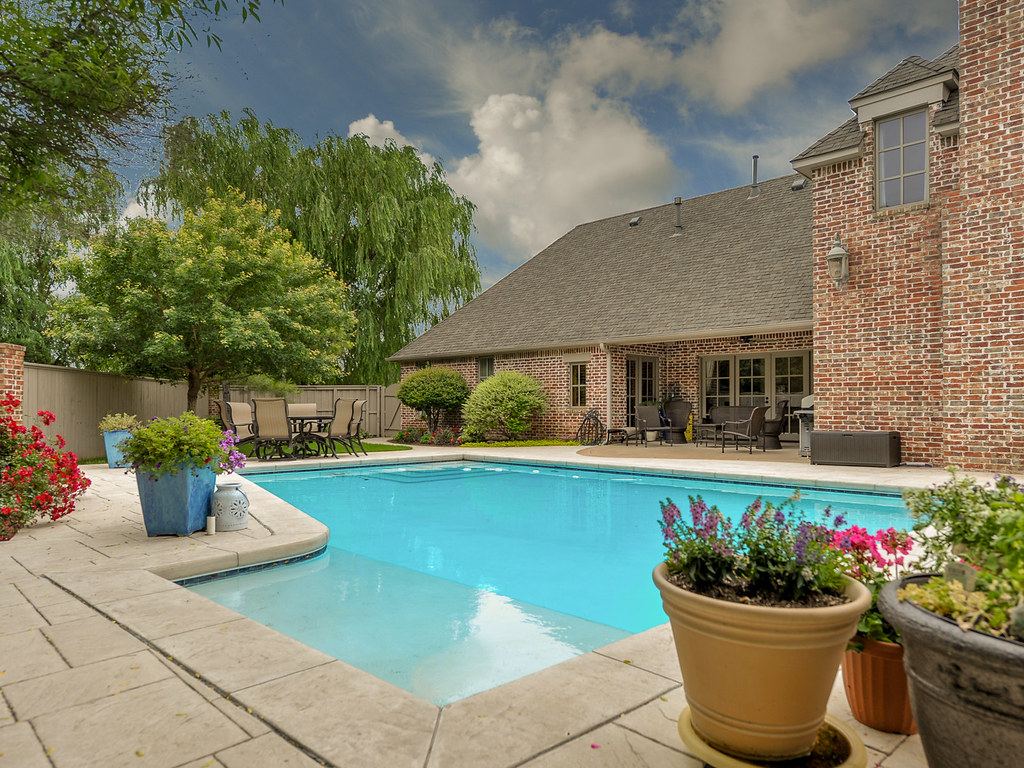 Backyard swimming pool with concrete surrounds