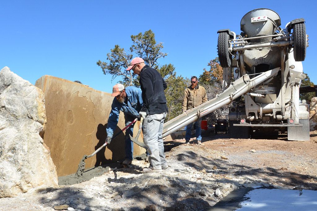 Concreters pouring a footing on site